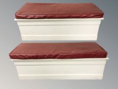 A pair of painted pine blanket chests with red leather cushioned seats, width 125 cm.
