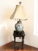 A small oak occasional table, height 43 cm, and a modern Chinese famille rose table lamp.
