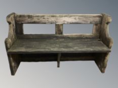 A pine pew, length 132 cm.