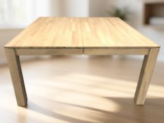 An oak extending dining table with two internal leaves, extended 213 cm x 150 cm x 75 cm.