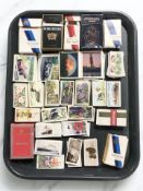 A quantity of cigarette cards and cigarette boxes.