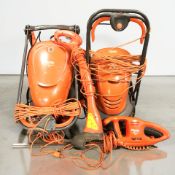 Two Flymo electric lawnmowers and a hedge trimmer.
