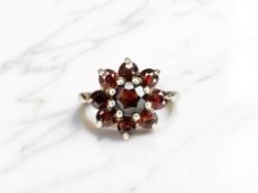 A 9ct yellow gold garnet cluster ring, size O CONDITION REPORT: 3.