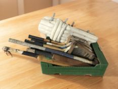 A group of vintage tennis rackets, cricket bats and other equipment.