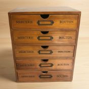 A reproduction five drawer chest