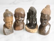 Four African wooden busts, tallest 21 cm.