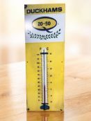 A reproduction Duckhams-style metal thermometer, 83 cm x 30 cm.