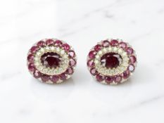 A pair of 14ct yellow gold ruby and diamond earrings featuring two oval cut rubies (1.