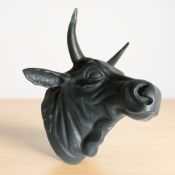 A large cast metal bull's head wall hanging,