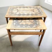 Two Danish Oxart teak and tile inset nesting tables, the larger 62 cm wide.