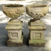 A pair of weathered concrete pedestal planters, height 87 cm.