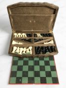 A resin chess set in oak case with board