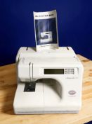 A Janome Memory Craft 5000 digital sewing machine, with instruction book.