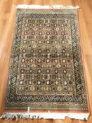 A machine made rug of Iranian design, 188 cm x 115 cm.