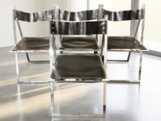 A set of four Elios chrome folding chairs with black leather slung seats and back rests,