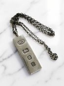 A silver Ingot, London 1976, suspended on white metal chain CONDITION REPORT: 29.