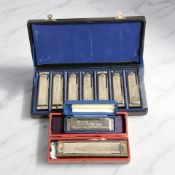 Two harmonicas in cases,