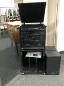 A Technics hi-fi system in cabinet with pair of speakers.