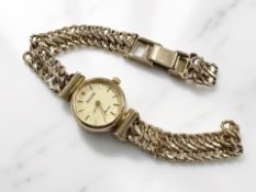 A lady's 9ct yellow gold Accurist wristwatch with 9ct gold fully integral strap.