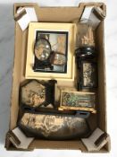 A group of oriental cork carvings in cases and frames.