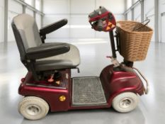 A Shoprider mobility scooter, with charging lead and user manual.