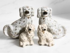 A pair of Beswick spaniel figures and a pair of Staffordshire dogs, tallest 21 cm.