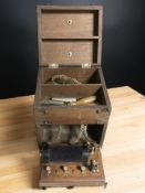 An antique mahogany cased electrode machine