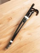 A rustic walking stick and two shooting sticks.