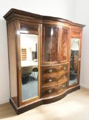 A Victorian flame mahogany bowfront four door wardrobe,