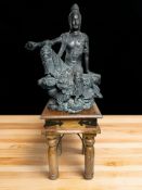 A small hardwood table, width 30 cm, and a heavy composition figure of Buddha.