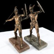 Two reproduction patinated metal figures of Achilleas on marble plinths, each 39 cm high.