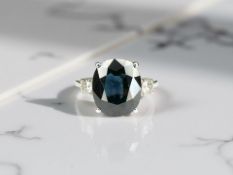 An 18ct white gold sapphire and diamond ring, size M/N. CONDITION REPORT: Sapphire 4.