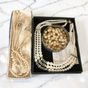 A group of costume pearl necklaces.