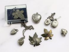 A group of silver heart-shaped lockets, a marcasite leaf brooch, maple leaf brooches.