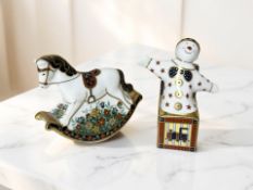 Two Royal Crown Derby Treasures of Childhood paperweights, 'Jack-in-the-box' and 'Rocking Horse'.