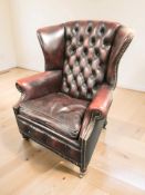 A 20th century Chesterfield oxblood wingback armchair, width 85 cm.