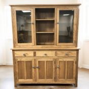 A reproduction oak bookcase, 137 cm x 42 cm x 169 cm.
