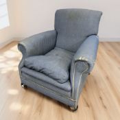An early 20th century club armchair in blue upholstery, width 90 cm.