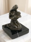A reproduction bronze figure of a mother with child on black marble plinth, height 11 cm.