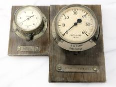 Two nautical pressure gauges on wooden plaques marked 'HMS Nelson' and 'HMS Prince of Wales'.