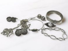 A group of silver/white metal jewellery including bangles, necklace,