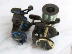 A Daiwa Sealine SL20SH power mesh drive fishing reel, a Penn 515 Mag 4 reel and a spool of line.