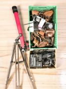 A telescope on tripod and two boxes containing assorted vintage and later cameras.