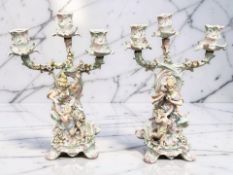 A pair of late 19th century continental encrusted three branch candelabra,