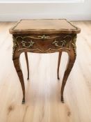A French rosewood and gilt metal mounted serpentine occasional table fitted a drawer,