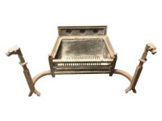 A 19th century cast iron fire grate with dog's head terminals, overall 114 cm W x 58 cm D x 64 cm H.