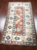 An Afghan / Caucasian design rug, 242 cm x 145 cm.