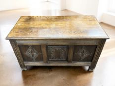 A reproduction carved oak blanket chest, width 90 cm.