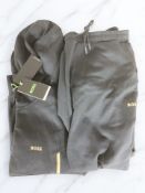 A Boss tracksuit top, size M, and tracksuit bottoms, size M, both with retail tags.