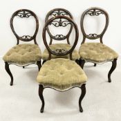 A set of four Victorian carved mahogany balloon back dining chairs.